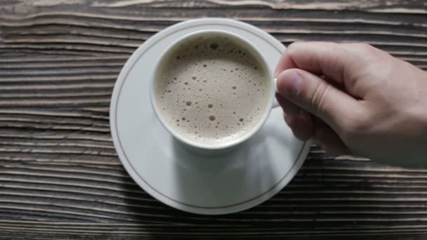 A cup of cappuccino with foam is on the table - Video, Çekim