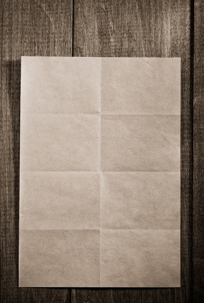 folded note paper on wood - Фото, изображение