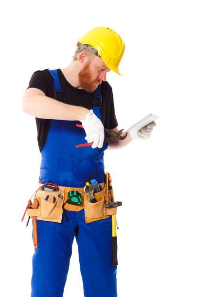 Man builder in the uniform with a tablet - 写真・画像