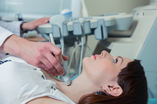 woman getting ultrasound of a thyroid from doctor - Zdjęcie, obraz