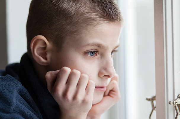 Pensive Boy Leans his Face on Hands at the Window - Photo, Image