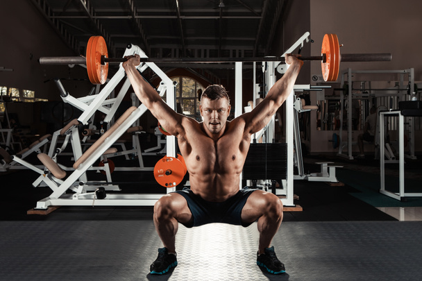 Muscular man  lifting a barbell - Fotó, kép