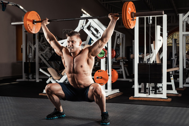 Muscular man  lifting a barbell - Photo, Image