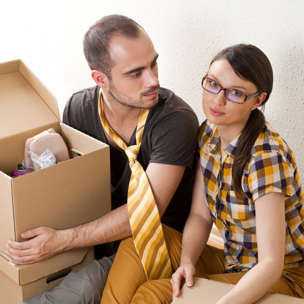 Casal jovem com caixas no novo apartamento sentado no chão um
 - Foto, Imagem