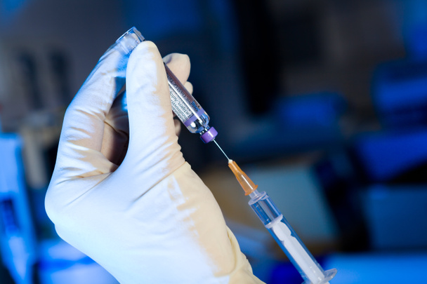 επιστήμονας με σύριγγα πιπίλισμα εμβόλιο, γάντια - Φωτογραφία, εικόνα