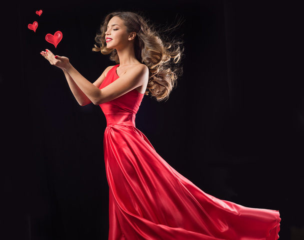 Young woman in red flying dress - Fotoğraf, Görsel