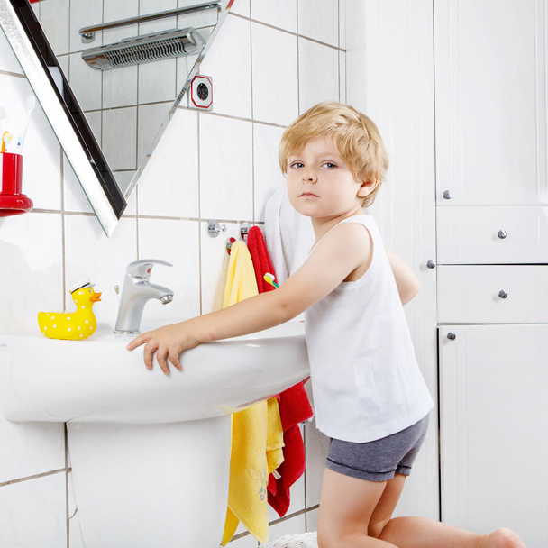 Lovely toddler boy brushing his teeth, indoors - Photo, Image