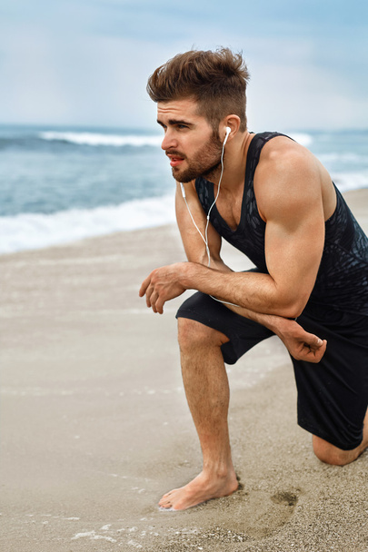 Tired Man Resting After Running On Beach. Sports Workout Outdoor - Photo, image