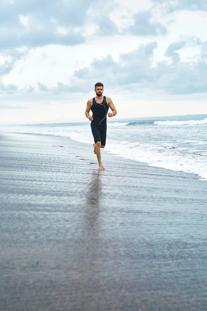 Man Running On Beach, Jogging During Outdoor Workout. Sports Concept - Фото, изображение