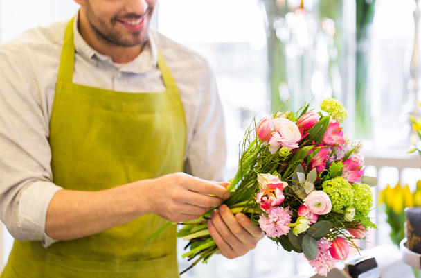 close up of florist man with bunch at flower shop - 写真・画像