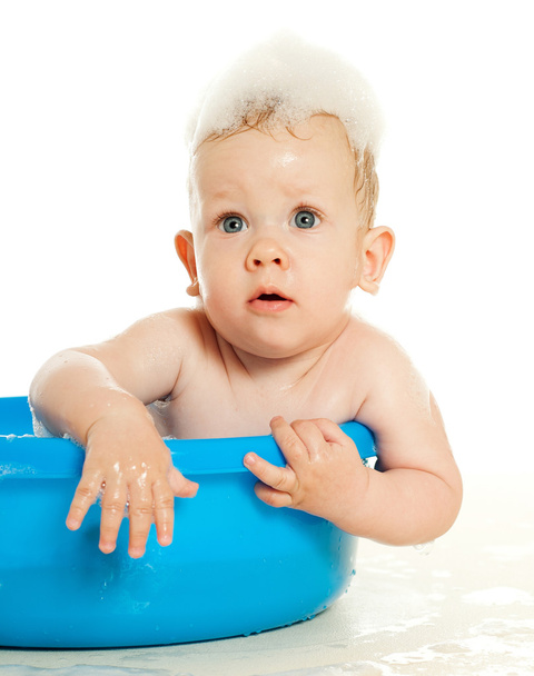 baby sitting in a blue tub - Photo, image