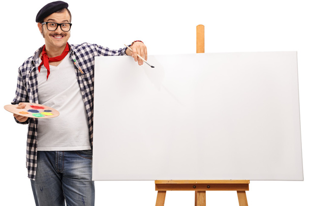 Eccentric artist posing next to a canvas  - Foto, Bild