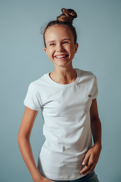 Smiling girl with  blonde hair on blue background.studio portrai - Fotoğraf, Görsel