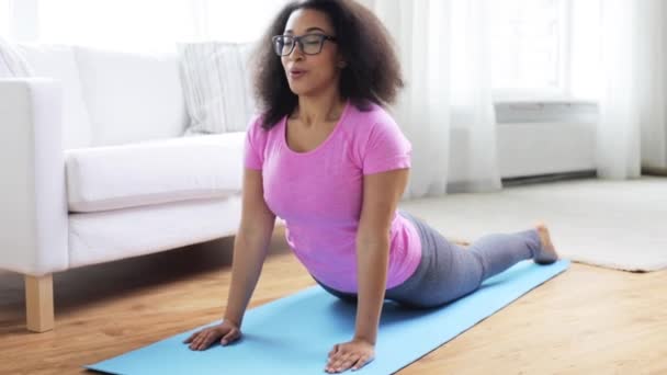happy african woman exercising on mat at home - Footage, Video