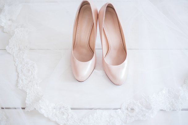 Beige wedding heels on bridal veil - Photo, image