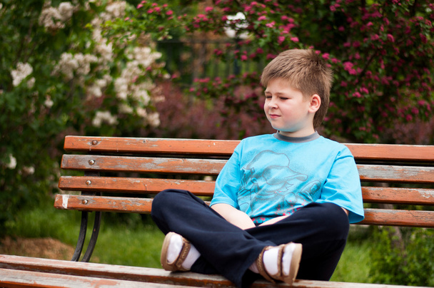 Sad boy sitting on a bench - Fotografie, Obrázek