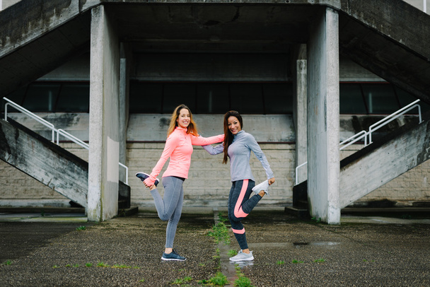 Young women stretching legs before running - Fotografie, Obrázek