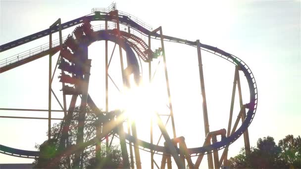 SLOW MOTION: People riding extreme roller coaster over the sun - Footage, Video