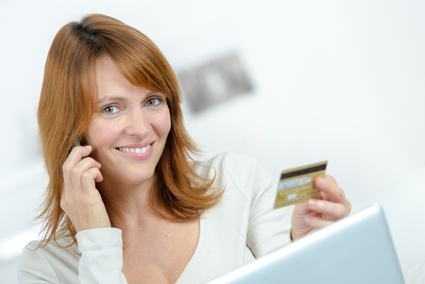 Lady on cellphone, holding credit card - Zdjęcie, obraz