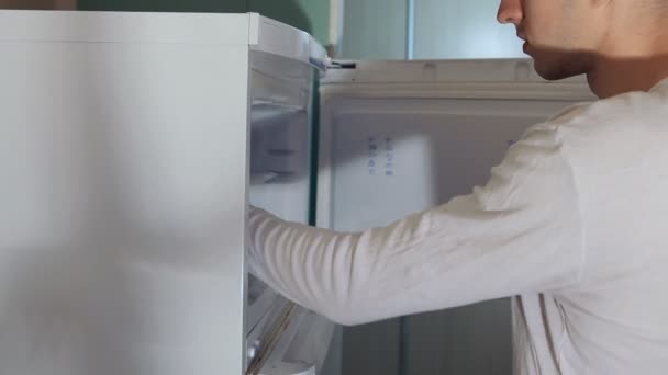 man takes meat from refrigerator - Záběry, video