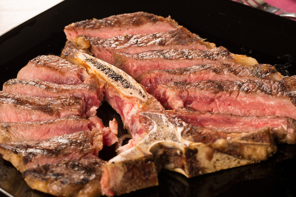 Sliced t bone steak on a plate - Photo, Image