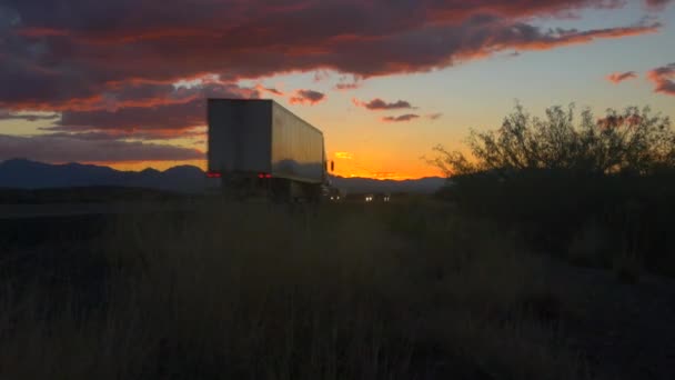 Autók és áruszállítási közlekedés félig teherautók vezetés a forgalmas autópályán, napfényes reggel - Felvétel, videó