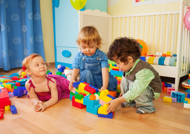 Kids playing with plastic blocks - Photo, Image