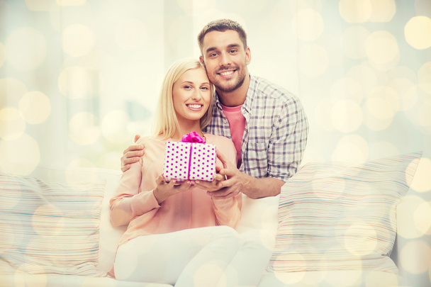 happy man giving woman gift box at home - Foto, imagen