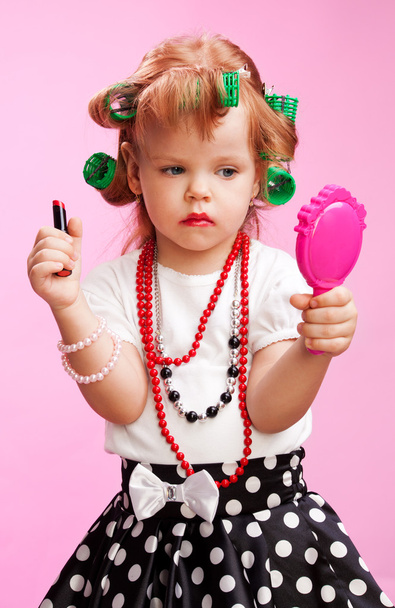 Little beautiful girl playing to be a big sister - 写真・画像