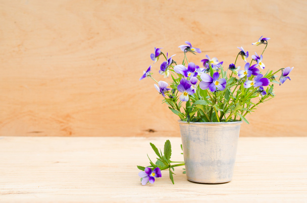 Spring flowers in vintage vase on wooden background, rustic style. - Photo, Image