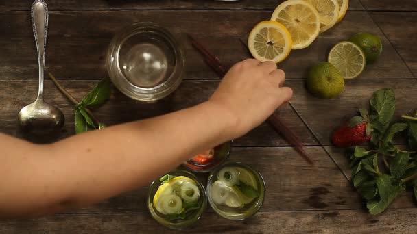 preparation of three summer cocktails on a wooden table. view from above - Filmmaterial, Video