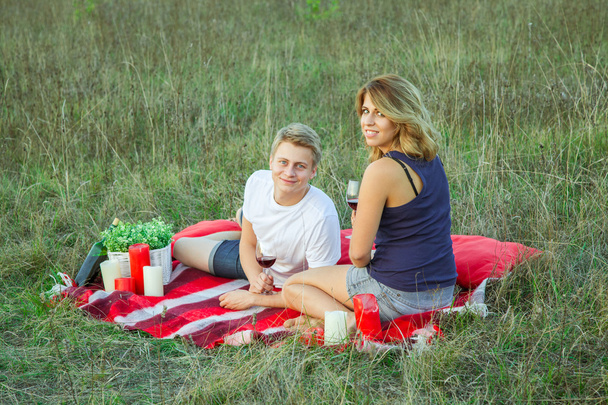 Lovely young beautiful couple resting in park - Фото, зображення