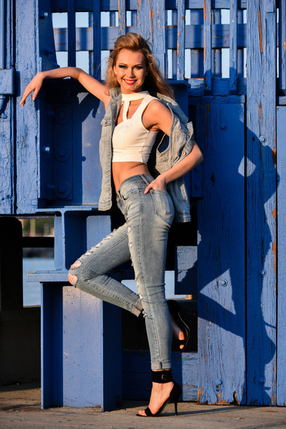 woman in ripped jeans and denim vest  - 写真・画像