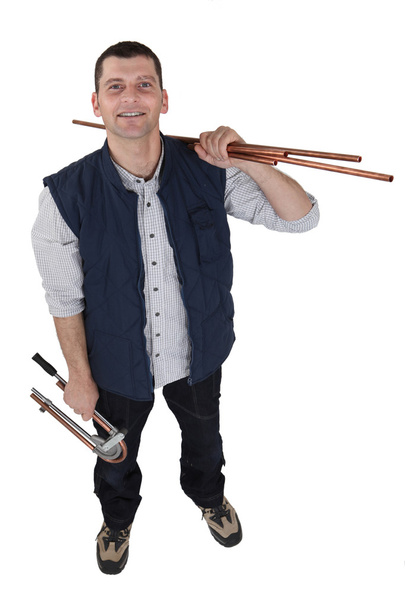 Plumber holding copper pipe - Zdjęcie, obraz