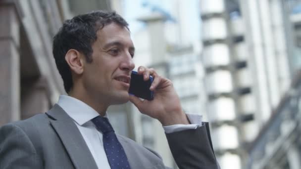  businessman talking on mobile phone - Кадри, відео