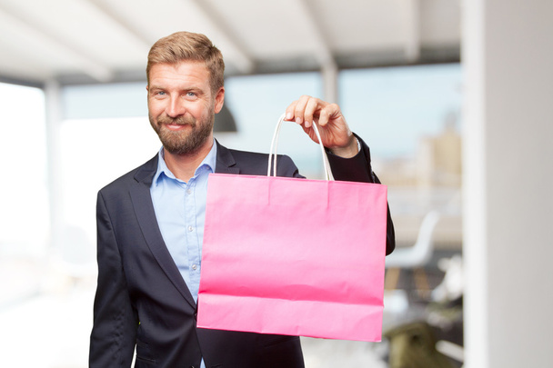blond businessman with shopping bag - Foto, Imagen