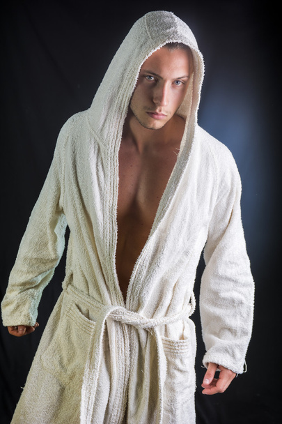 Handsome young man wearing white bathrobe - Foto, Imagen