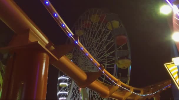 Rides at amusement park in the evening, no movement. - Footage, Video