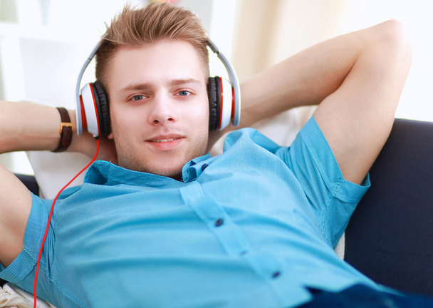 Man listening music with headphones at home - Fotoğraf, Görsel
