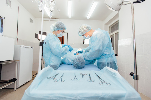 Surgeons team working with Monitoring of patient in surgical operating room. breast augmentation. - Fotoğraf, Görsel