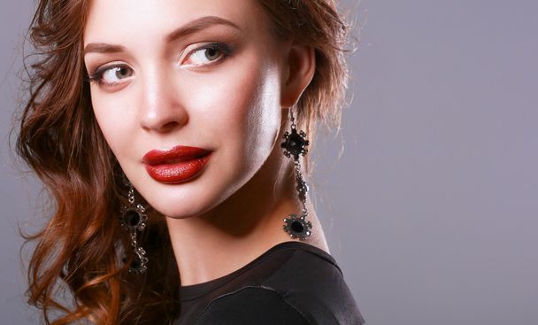 Beautiful woman with evening make-up in black dress - Фото, изображение