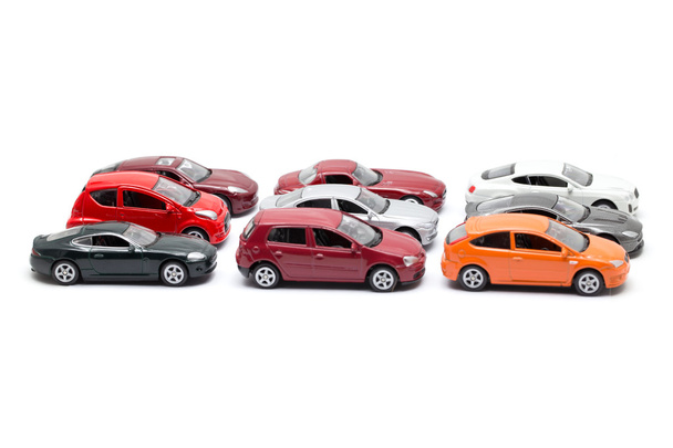 іграшкові автомобілі, розташовані на білому тлі
 - Фото, зображення