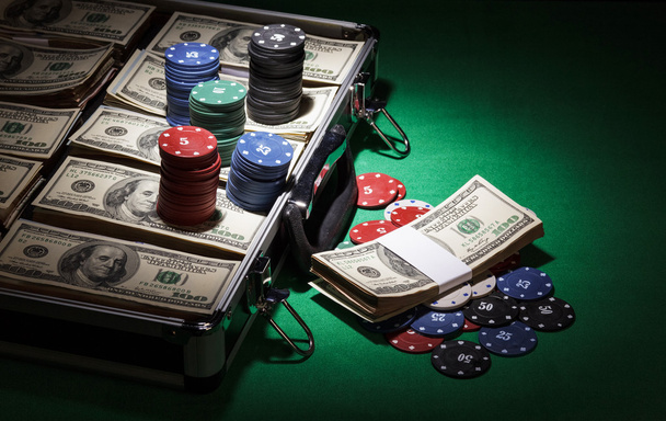 Case with dollars and chips on green cloth background - 写真・画像