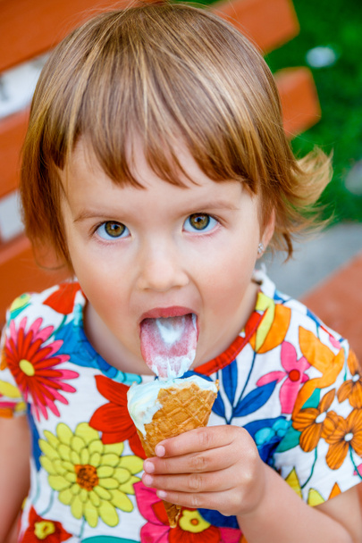 happy little girl licking an ice cream - Фото, зображення
