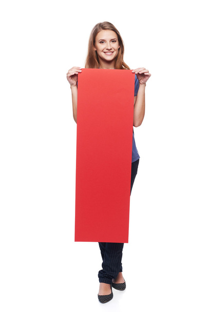 Woman holding red blank cardboard - Zdjęcie, obraz