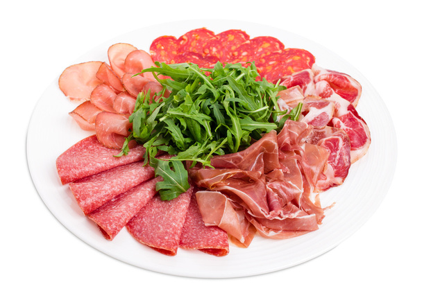 Delicious meat platter with arugula. - Foto, afbeelding