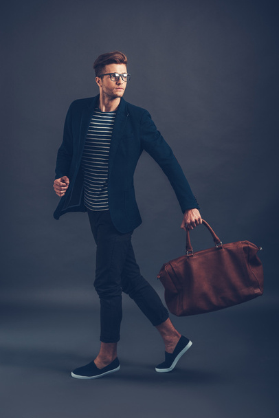 man in glasses carrying bag - Foto, imagen
