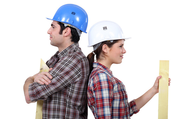 Male and female builders back to back - Φωτογραφία, εικόνα