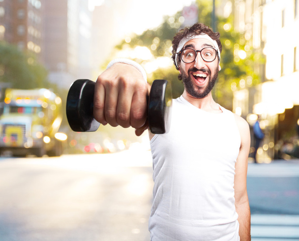 young crazy sportsman with dumbbell - Fotoğraf, Görsel