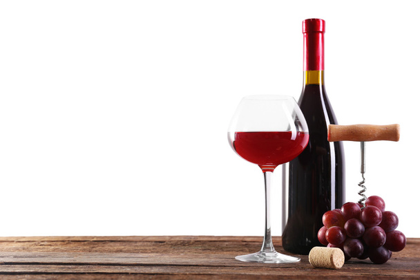 Wine and grape on wooden table against light background - Foto, immagini